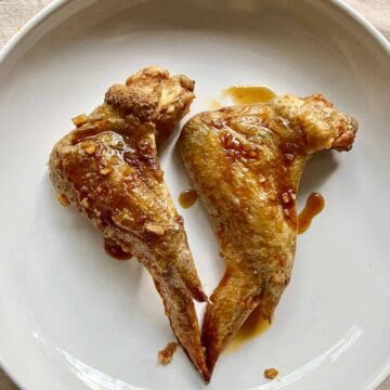 2 baked chicken wings that are super crispy and have been tossed in a sticky Vietnamese glaze.