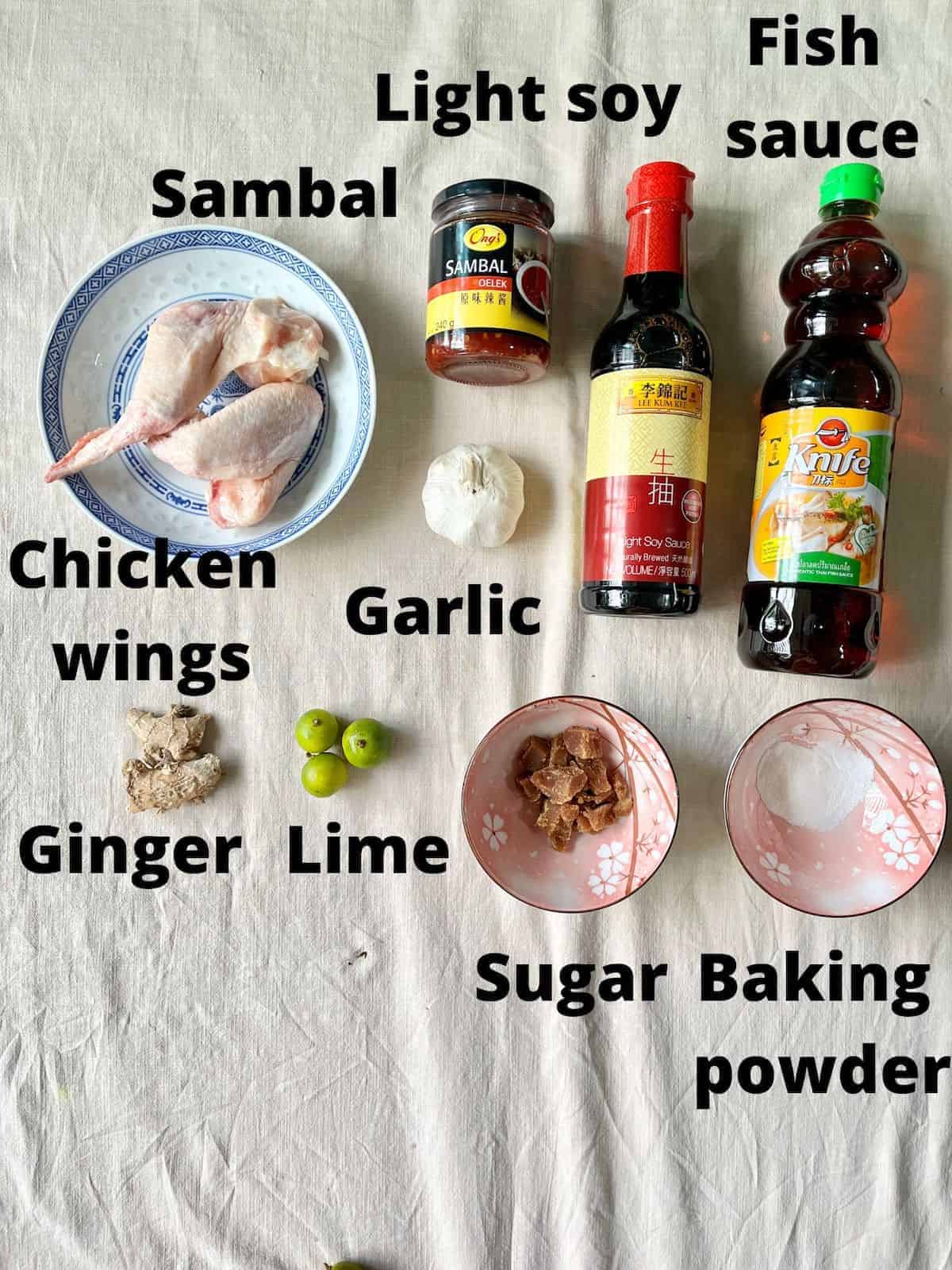 The ingredients required for baked Vietnamese fish sauce wings on a linen cloth.