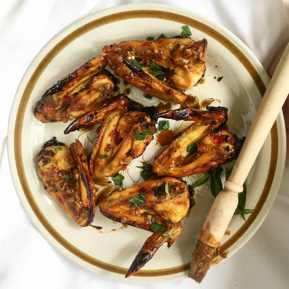 6 baked vietnamese fish sauce chicken wings on a vintage plate.