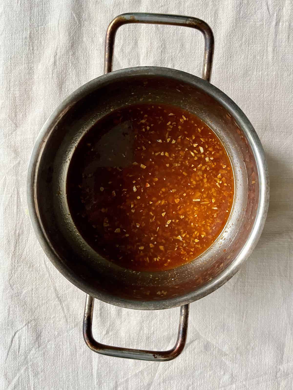 The ingredients for fish sauce chicken wings boiled down in a pot.