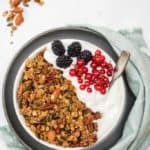 Bowl of homemade pumpkin seed granola with yogurt and fruit