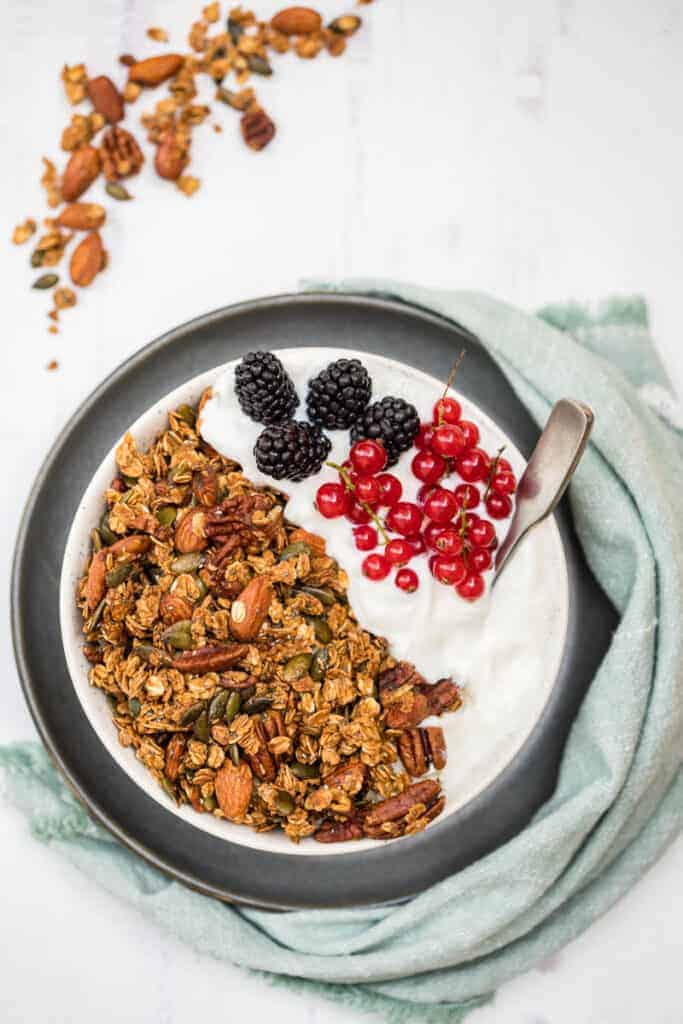 Bowl of homemade pumpkin seed granola with yogurt and fruit