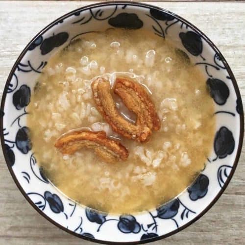 Close-up of brown rice cook in a blue and white bowl.