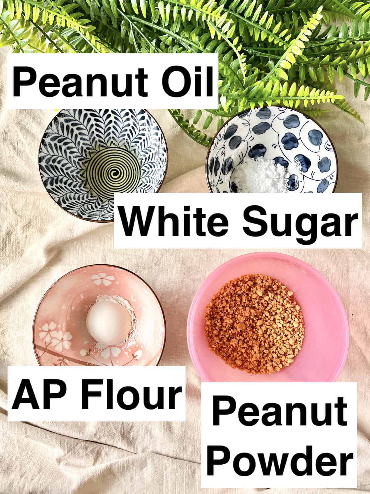 A bowl of peanut oil, sugar, white flour and peanut powder next to each other.