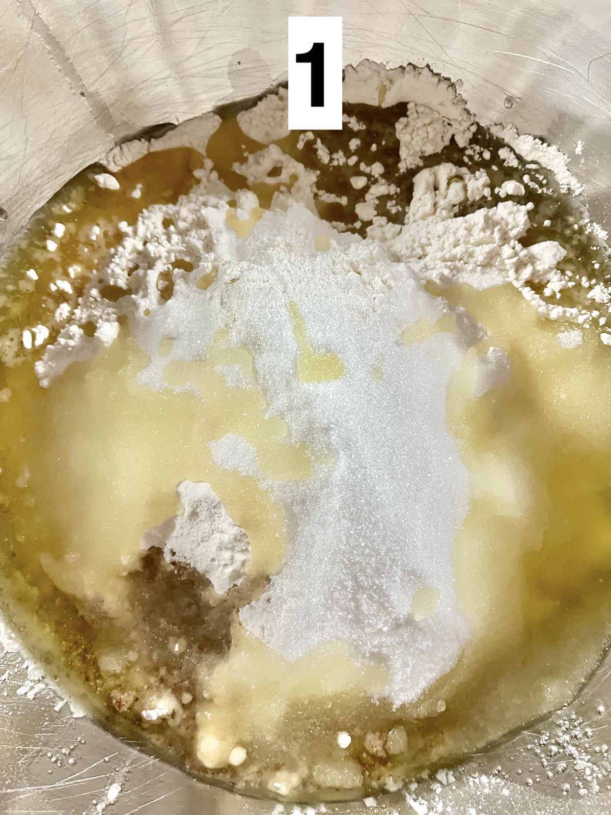 Close-up of flour, sugar, nut flour and oil in a mixing bowl.