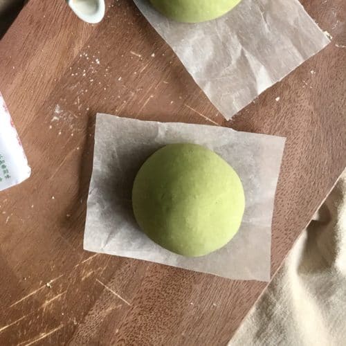 1 matcha green tea bun before being steamed.