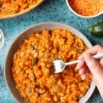 Fork dipping into a bowl of baked bean curry