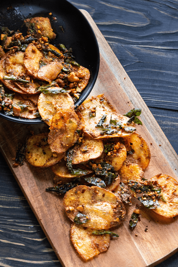 A platter of crispy homemade potato chips cooked in salted egg