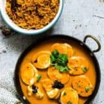 A pan of egg curry and a bowl of rice