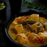 A bowl of Indian fish curry made with curry leaves