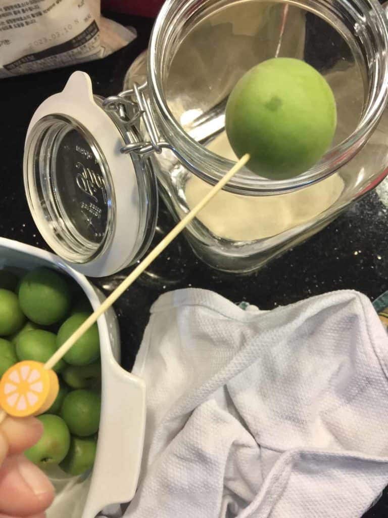 Pricking holes in the green plums for fermenting maesil-syrup