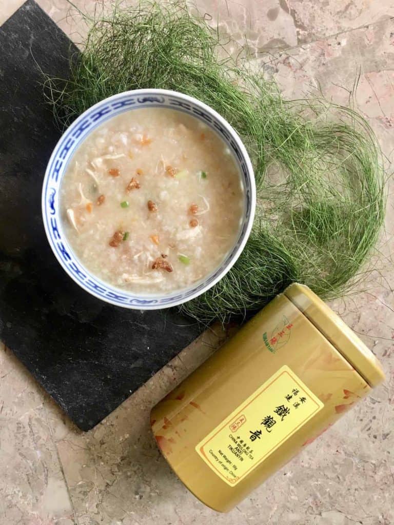A bowl of chicken rice porridge and tea