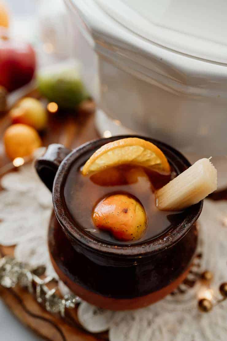 A mug of Mexican Christmas punch made with fruits and tamarind