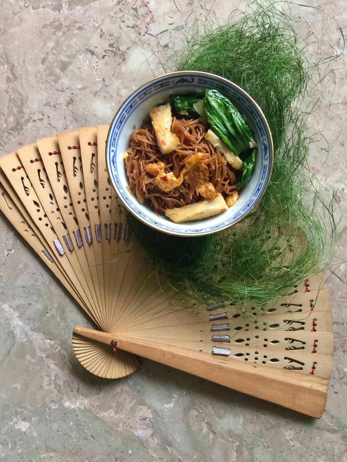 A bowl of Singaporean bihun goreng made with blanched bihun.