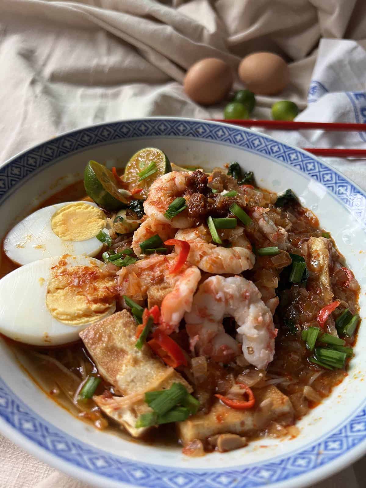 A bowl of sumptuous Mee Siam Noodles with prawns, egg, tofu and Chinese Koo Chye.