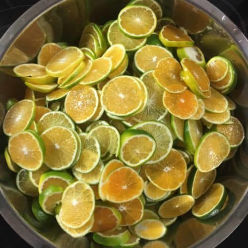 A bowl of sliced Korean green tangerines used to make cheong