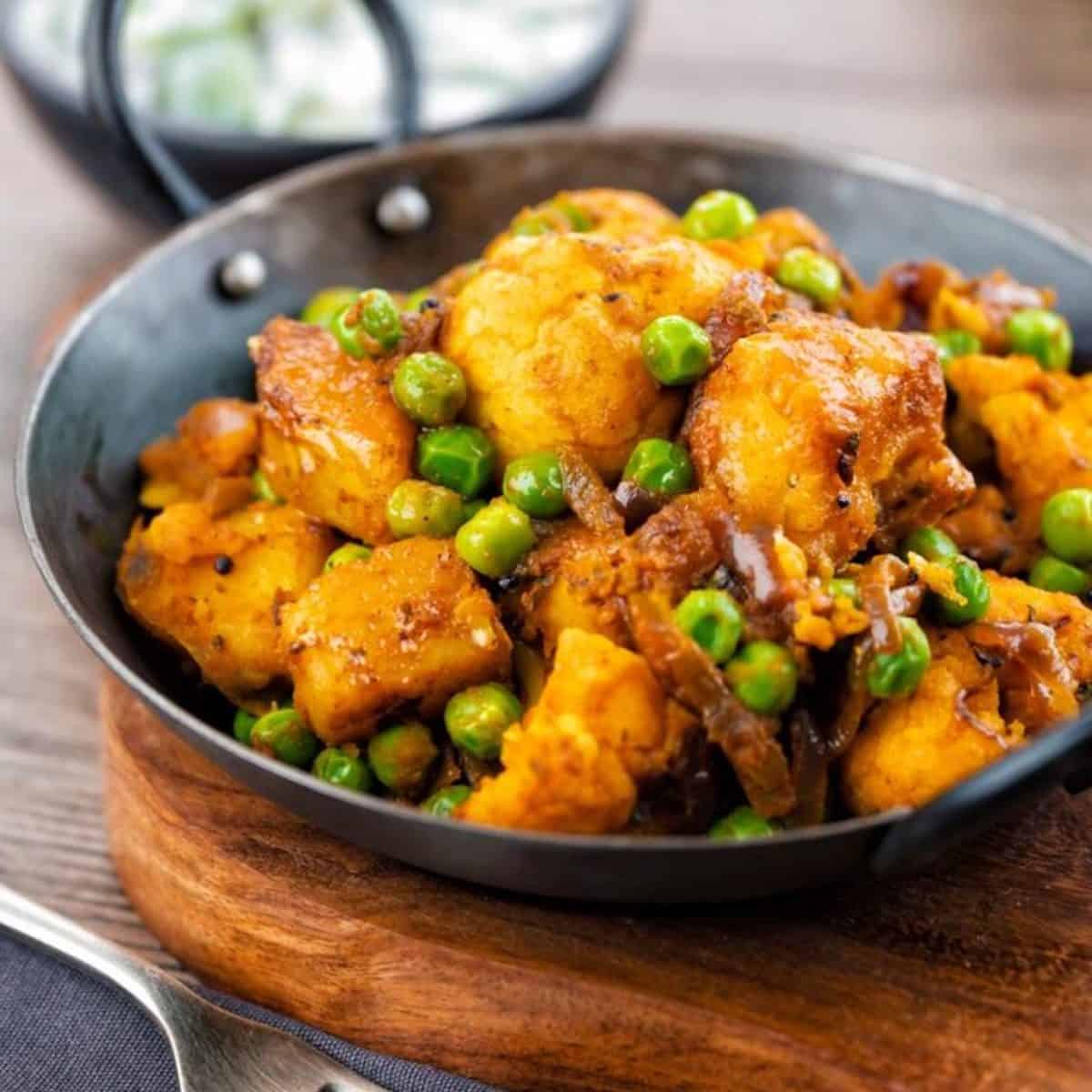 Close-up of Indian Aloo Gobi Matar potatoes.