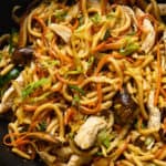 a close-up of a plate of chicken yaki udon noodles