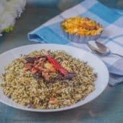 A plate of rice fried with curry leaves.