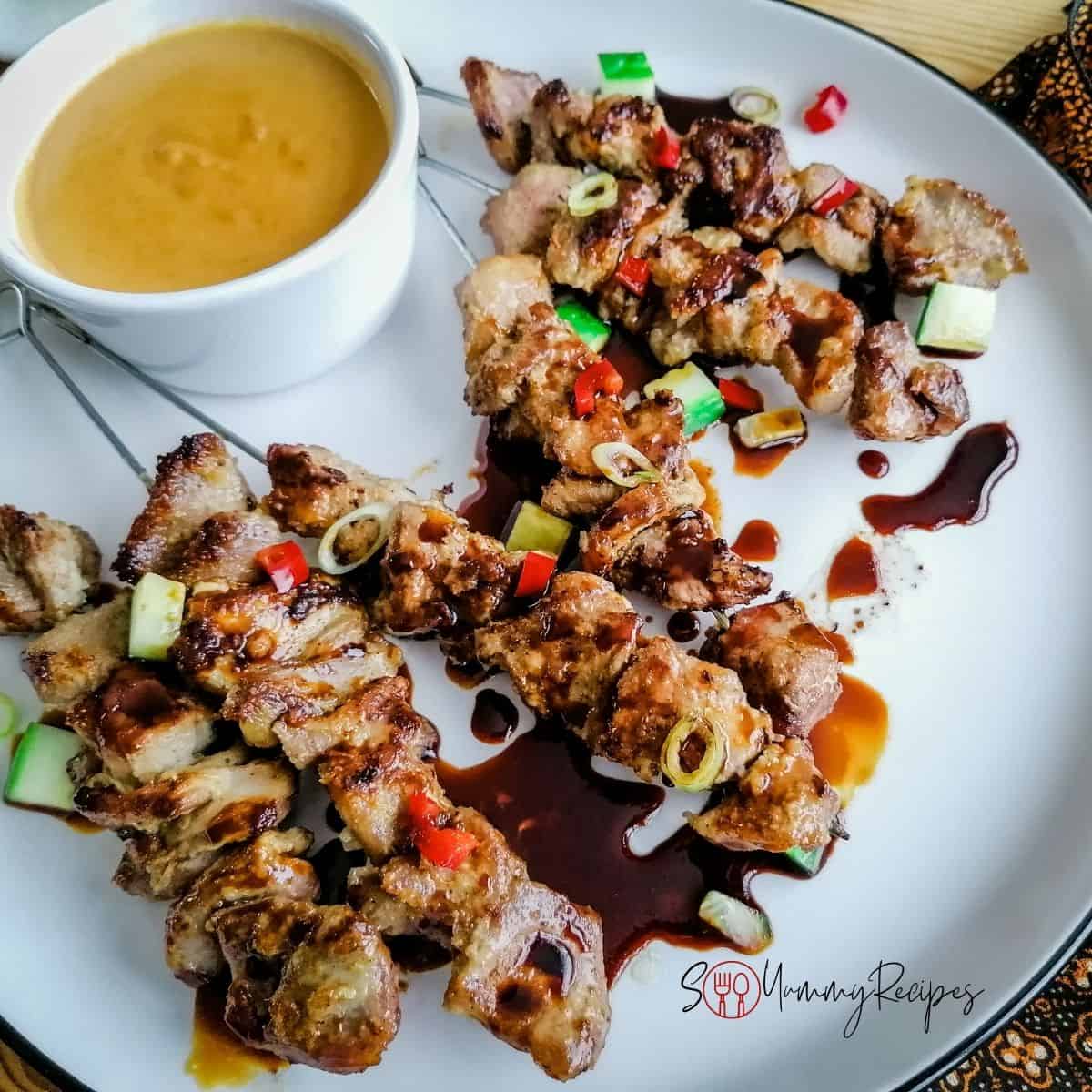 Skewer of lamb satay on a plate.