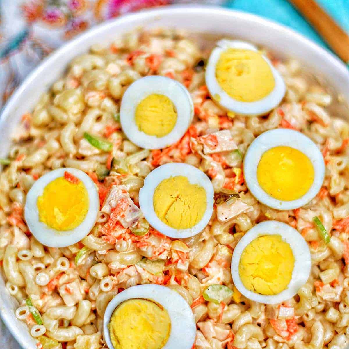 Close-up of hardboiled eggs and rotisserie chicken macaroni salad.