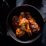 Chicken wings with ginger and lime, plated restaurant style.