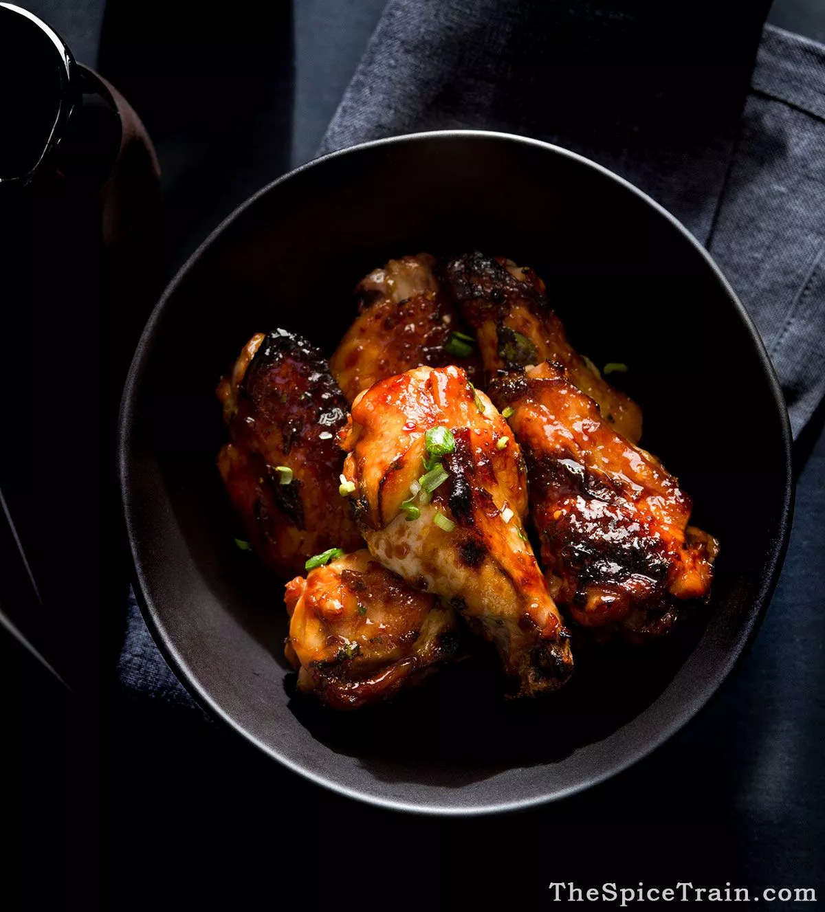 Chicken wings with ginger and lime, plated restaurant style.