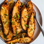 A plate of sweet potato wedges roasted in miso and honey