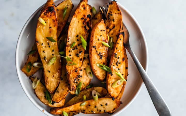 A plate of sweet potato wedges roasted in miso and honey