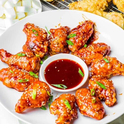 Korean Fried Chicken Wings arranged around dipping sauce.