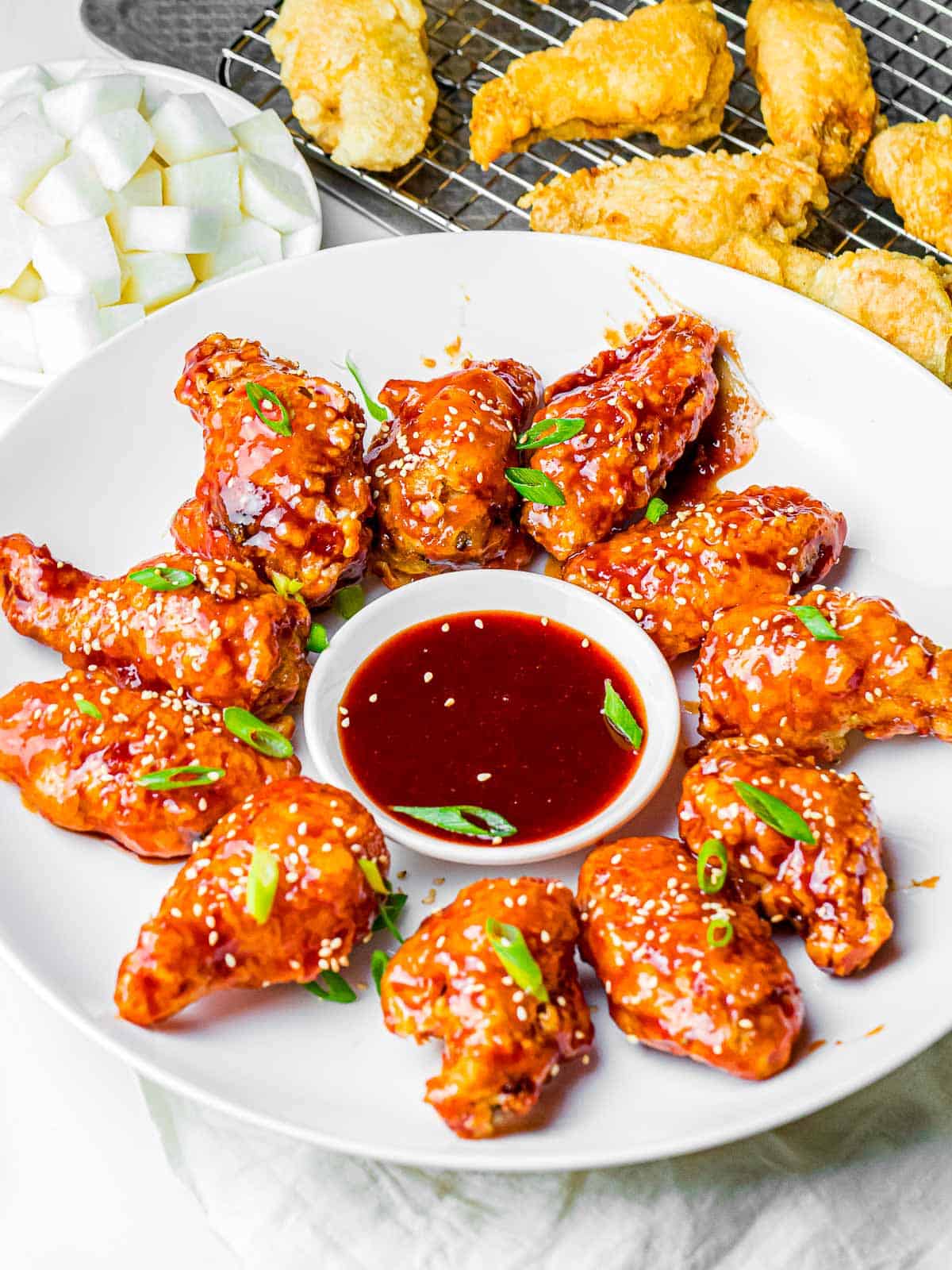 Korean Fried Chicken Wings arranged around dipping sauce.