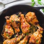 Chicken drumlets coated with maple miso sauce in a black skilled