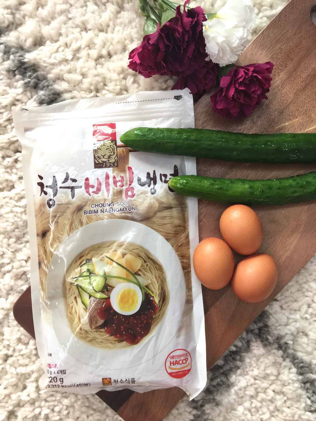A packet of instant Korean cold noodles with cucumber and eggs