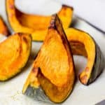 A few pieces of roasted kabocha squash on a plate