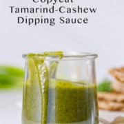 A green tamarind sauce in a glass container.