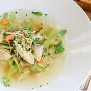 Close-up of a clear chicken & lemongrass soup.