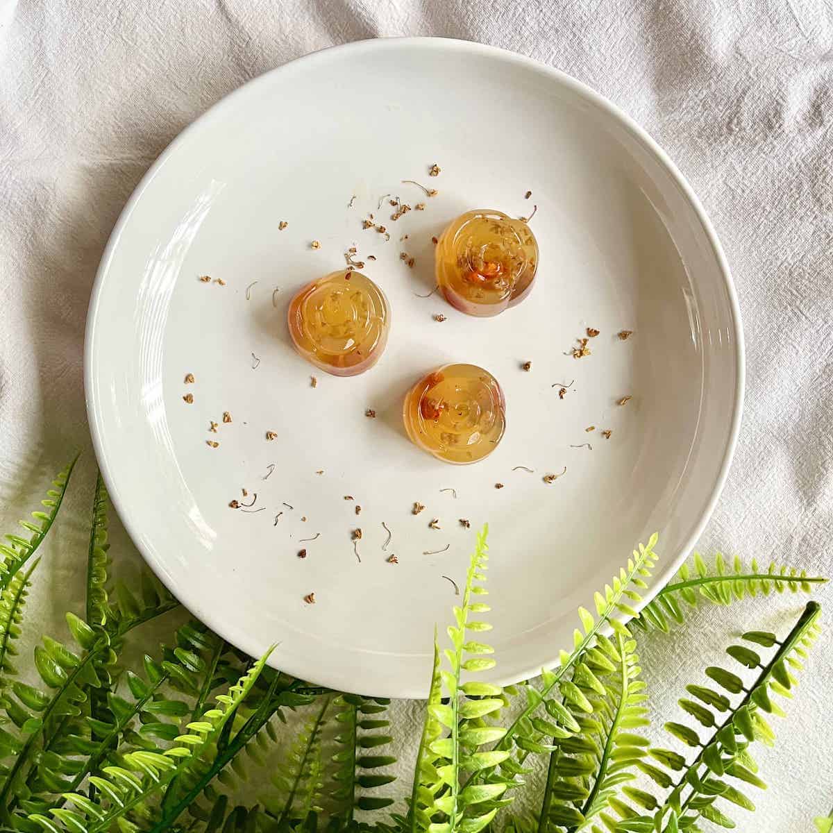 3 osmanthus jellies made with agar agar powder on a white plate.