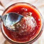 A spoon dipping into a jar of Christmas jam