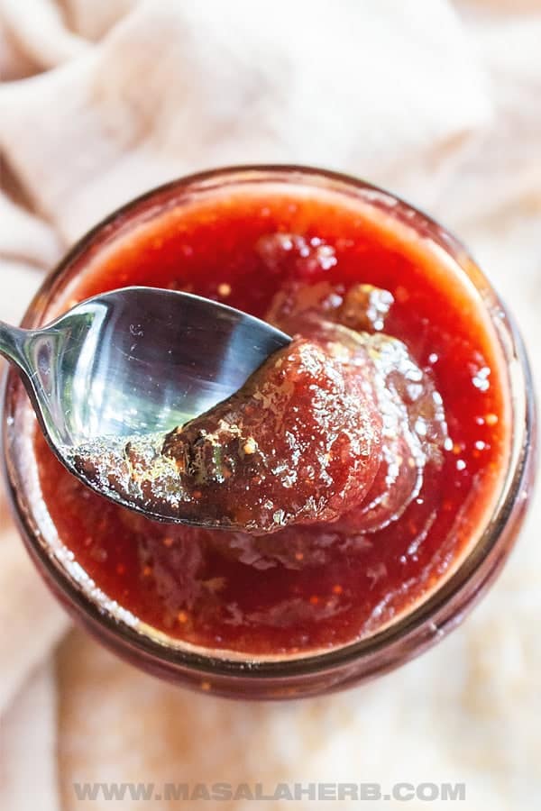 A spoon dipping into a jar of Christmas jam