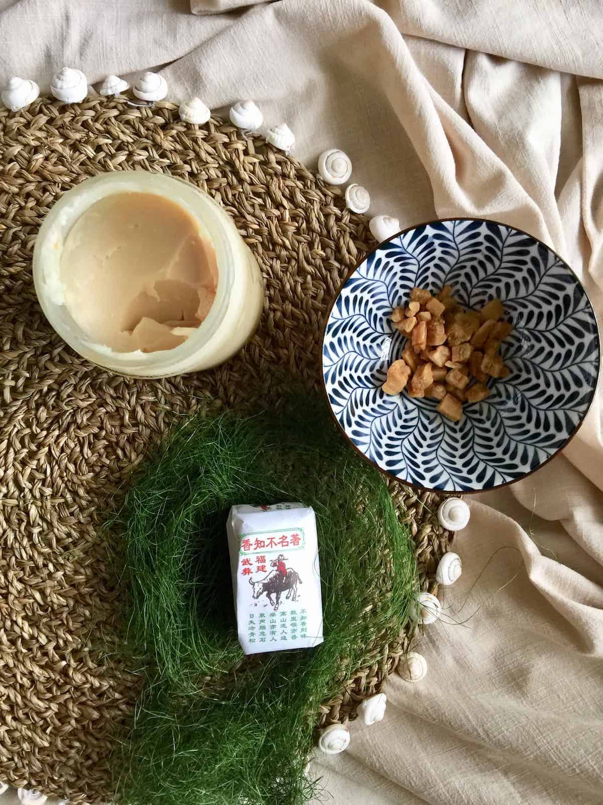 A jar of home rendered pork lard next to a bowl of crispy cracklings.