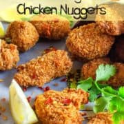 Many lemongrass chicken nuggets fried to a golden crisp lined up on baking paper.