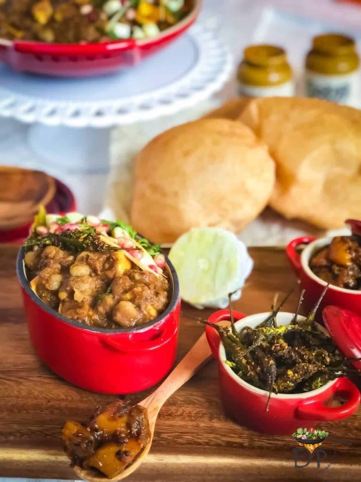 Chickpea and potato curry in a red container.