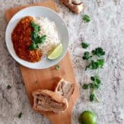 A plate of red lentil curry with rice.