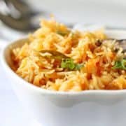 A side view of an Indian tomato rice dish.