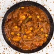 A bowl of red vegan vindaloo curry.