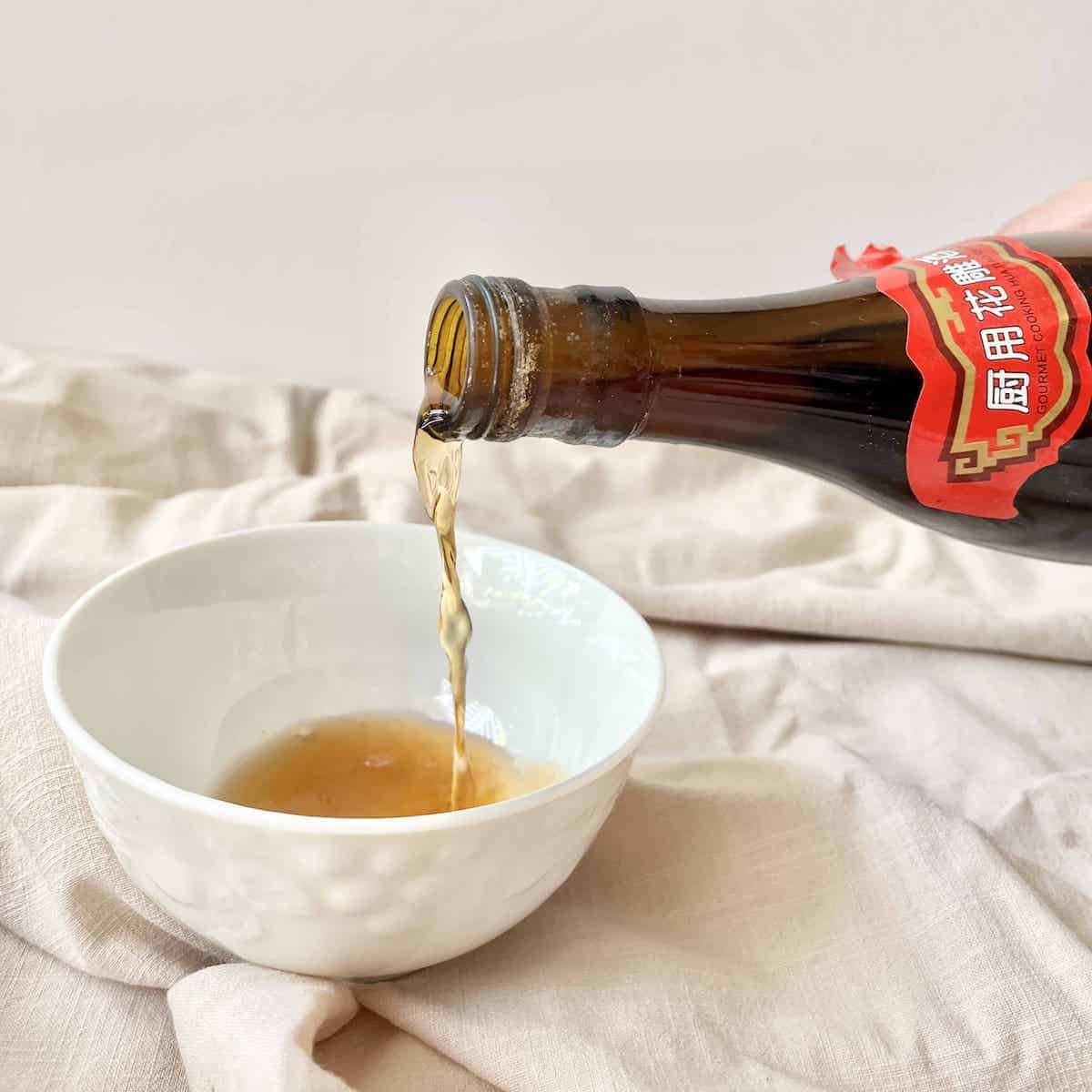 Pouring Chinese rice wine into a bowl.