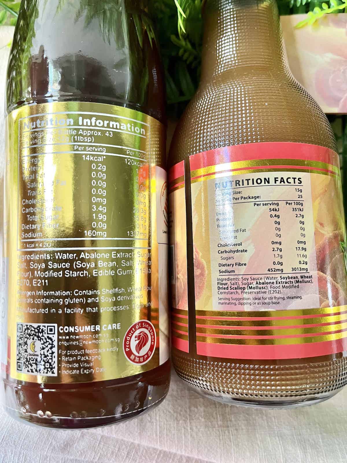 Ingredients listed on the labels of 2 different bottles of abalone sauce.