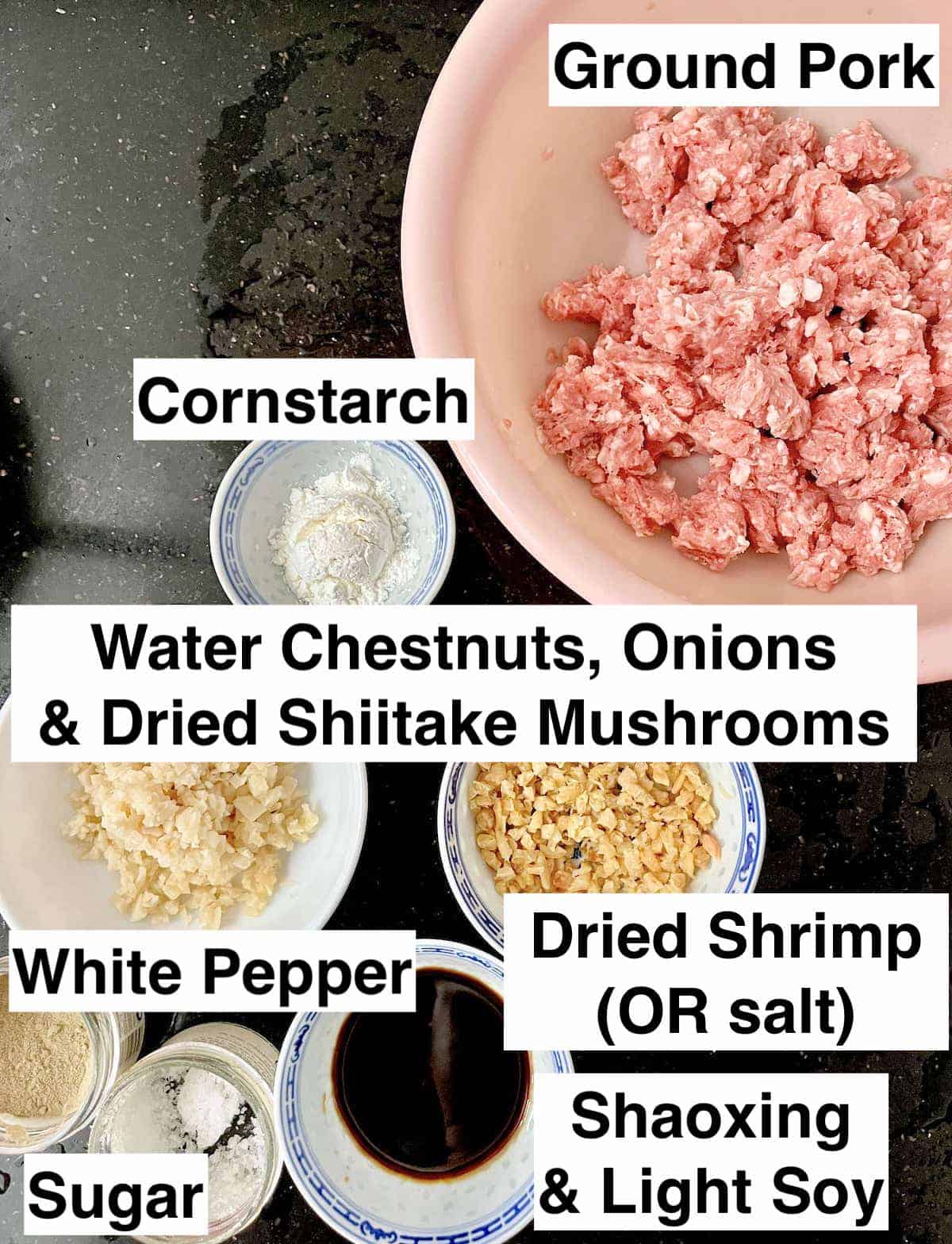 The ingredients needed to make meatballs on a black surface.
