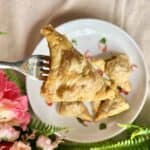 A baked samosa with a puff pastry exterior.