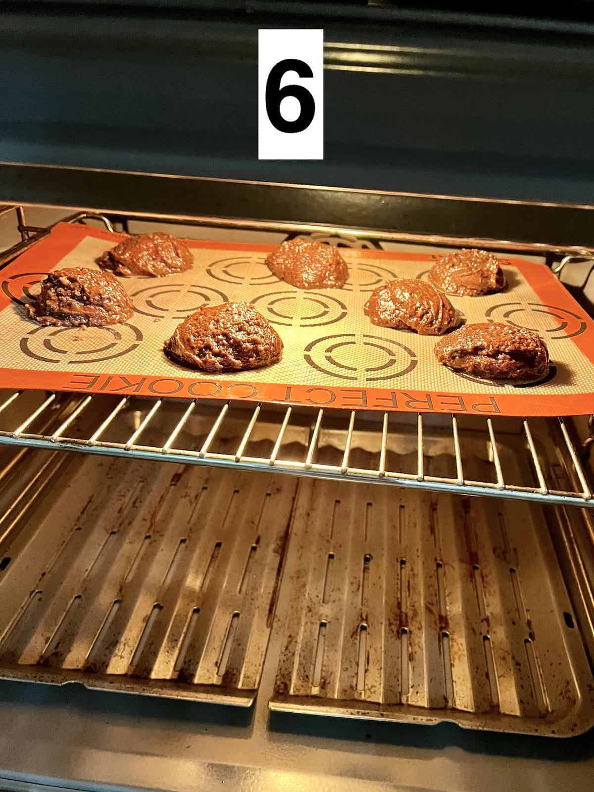 A tray of black sesame cookies in the oven.